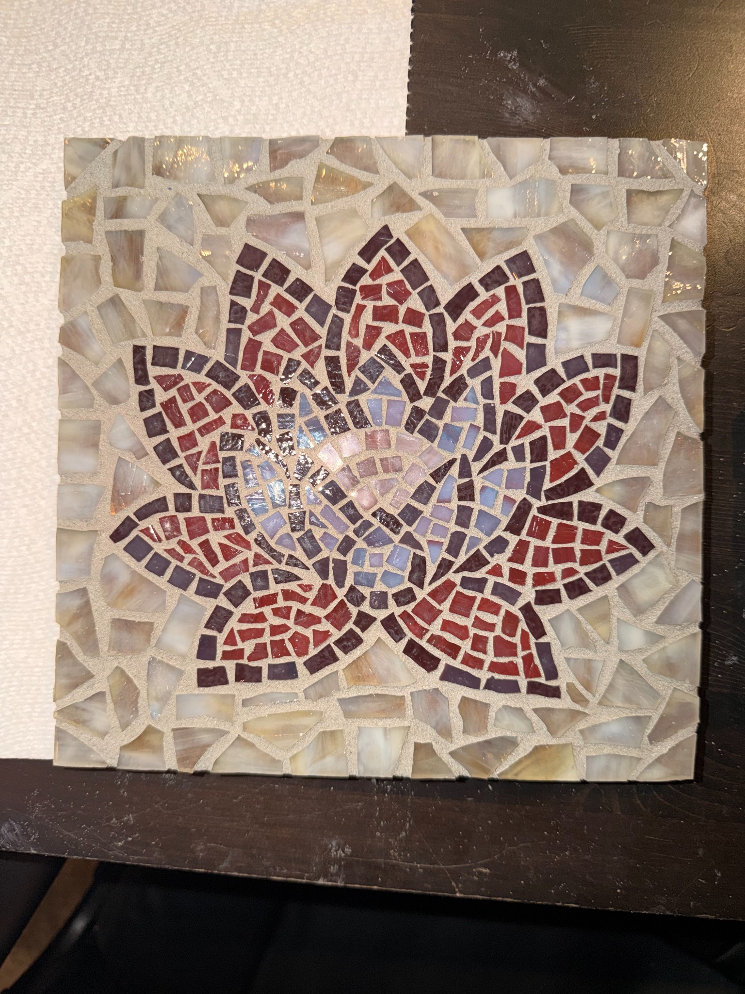 Jake’s finished lotus glass mosaic, with red and purple petals and pale iridescent glass
